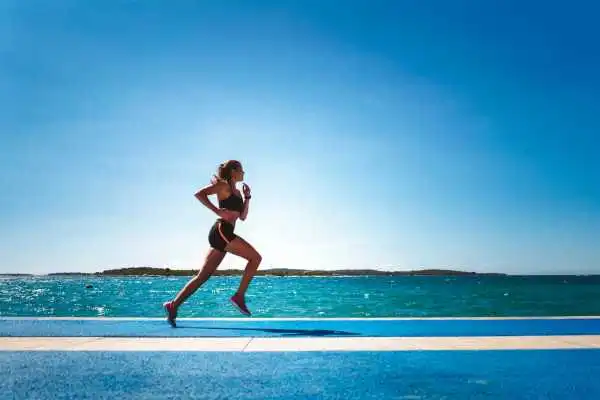 Woman running showing strong leg muscle Govan